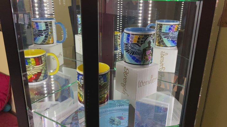 Video of colorful angel mugs in a mirrored cabinet